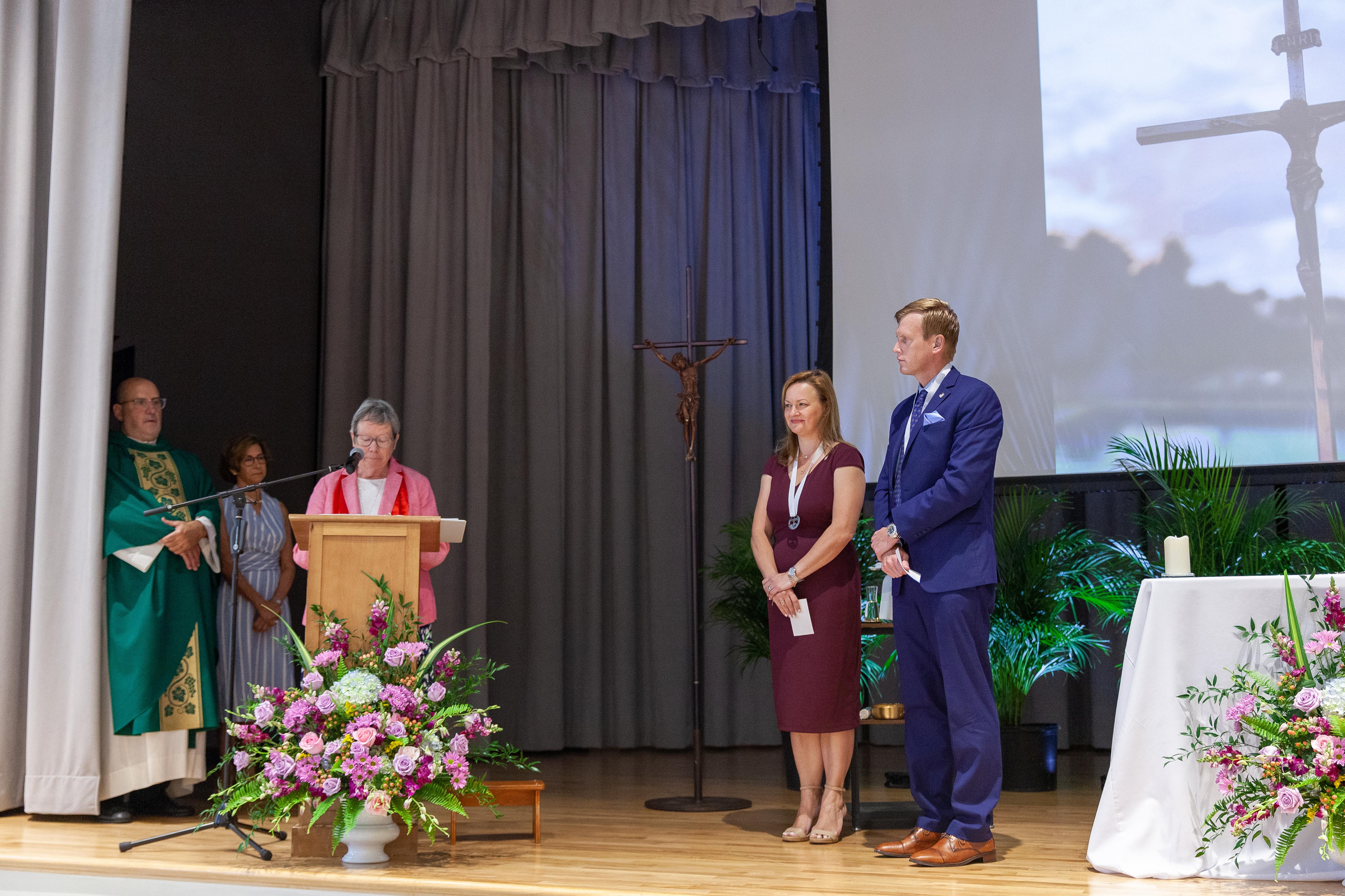 Provincial Suzanne Cooke, RSCJ, leads a blessing over Heather Gillingham-Rivas and Patrick J. Coyle. (Photo courtesy of Carrollton School of the Sacred Heart)