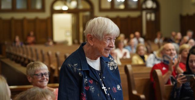 Sister Lucy Hayes stands to be recognized after Meg Brudney announced the dedication of the Duchesne sacristy  in her honor.