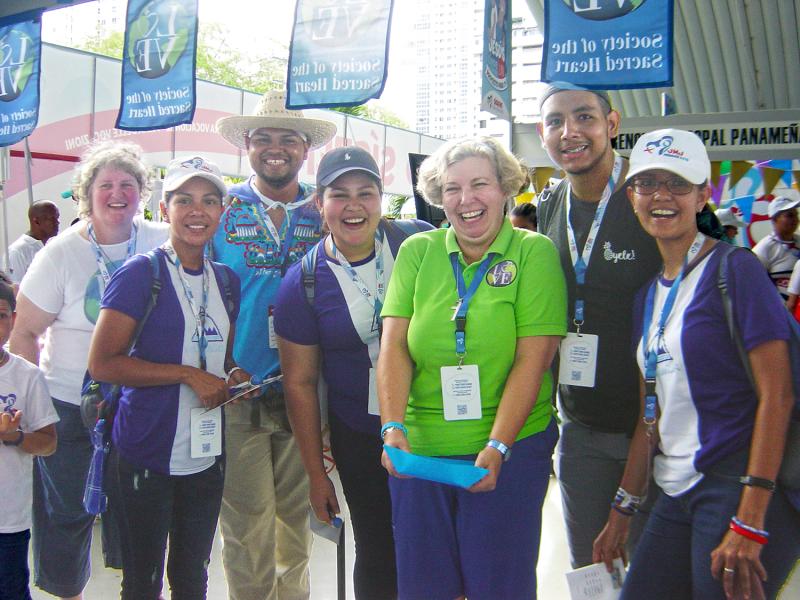 Lisa Buscher, RSCJ, (far left) and Mary Finlayson, RSCJ, (in green) welcoming pilgrims at the Vocation Fair of World Youth Day 2019, Panama.