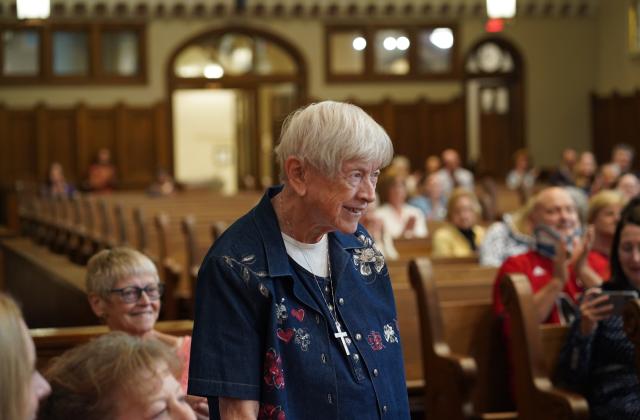 Sister Lucy Hayes stands to be recognized after Meg Brudney announced the dedication of the Duchesne sacristy  in her honor.